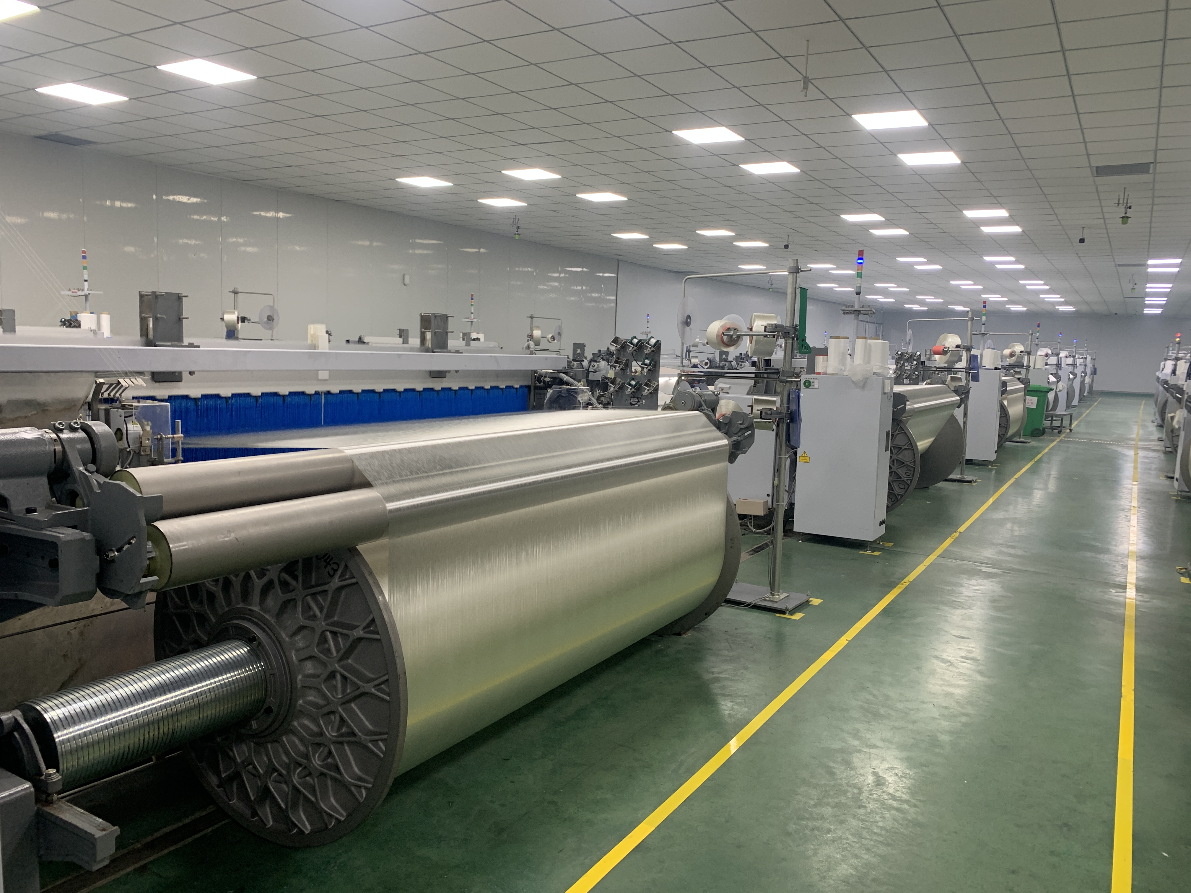 High-tech textile manufacturing facility with advanced machinery and clean environment, professional industrial setting